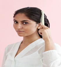 Spritz some spray gel (Brill likes Kérastase Texture Expert Lotion Densitive GL) from root to tip to give hair pieciness as it dries. Using a wide-tooth comb, spread the gel throughout the hair as you comb it backward, away from the face. Brill says it's important to use a gel that doesn't flake, because when it dries and you take it down, you're going to be shaking around the roots and you don't want to look like you've got dandruff. MultiBun_008_R