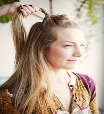 Step 3: Add a second section of hair an inch below the first and combine the loose tail with that from your first knot. style2_step3