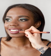 Line the lips with a pinky-nude lip pencil, then fill in the lips with a matching lipstick, preferably one with a glossy finish like Make Up For Ever Rouge Artist Intense in #49. 31_HalloweenLook3_091512_379