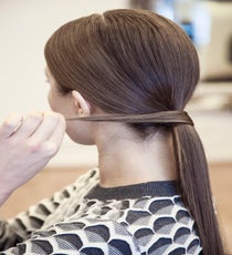 Simply pull the hair into a ponytail. Then, take a little piece of hair from underneath the ponytail and wrap it around the hair elastic, securing it with a hair grip. The piece of hair should be just thick enough to completely cover the elastic. 04__MG_6901