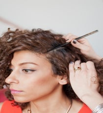 Step 2: Use a chopstick to part hair on both sides at the temples. 03_02_Style1_Step1
