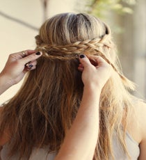 Step 5: Loop the remainder of the braids back in the opposite direction and pin to create a woven effect. Then, tuck the loose ends under your braids to hide the elastic bands and secure with pins. R29_Courtney109