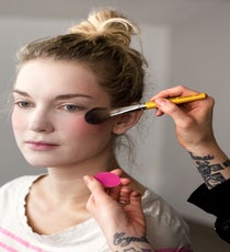 Using a bright pink powder blush, Evans applied the color on the cheeks in an upward motion, wrapping it up and around the eyes. The color from the cheeks will blend into the color of the eyes to intensify that eccentric effect. 04_HalloweenLook1_091512_072