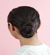 By keeping the comb lines very defined, it ages down the look and roughs it up, keeping it from looking too prissy or matronly, according to Brill. The sculpting combined with the styling gel helps create a defined, dressed-up 'do that's practically a work of art. LowBun_208_R