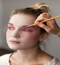 Apply Make Up For Ever Eyeshadow #75 — a neon pink — to the entire eyelid, including under the brow, and the inner corner of the eye. "Carry this color from the outer corner of the eye down onto the cheeks, then blend to diffuse the edges," says Evans. 06_HalloweenLook1_091512_145