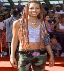 2001
Okay, okay, remember: It's 2001 and style was a bit weird, then. And for anyone who has ever been a 14-year-old kid sister, things are awkward — especially when your sibling is a) Beyoncé and b) taking you to the paparazzi-crazed BET awards. The camo, the exposed navel, and the glittery cropped top are so aughts — but we can all agree, those braids are pretty kickin'.
Photo: Al Tumo/Rex USA. solange-2001