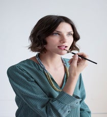 Before you start brushing your teeth, use your dry toothbrush to exfoliate your lips and remove any dead skin. Apply a dab of lip balm to your lips, then blot it off with a tissue to remove excess — this will hydrate your pout and ensure the lipstick doesn't wipe off after you apply.
Use a lip brush to paint on a dramatic lip color, like Tom Ford Lip & Cheek Stain Color (new for fall. Our hearts stopped when this landed on our desk — it's that
pretty). "A lip brush gives you a better shape, especially with bold colors," says Lake.
Joie Marlo D Top, Noise Girl Lyle Necklace quick-beauty-5